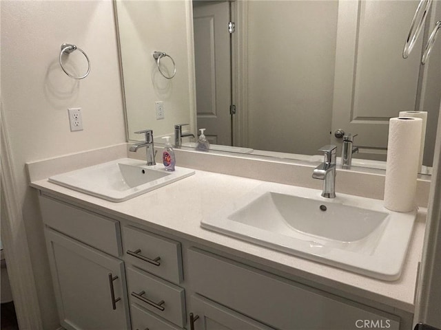 full bath featuring double vanity and a sink
