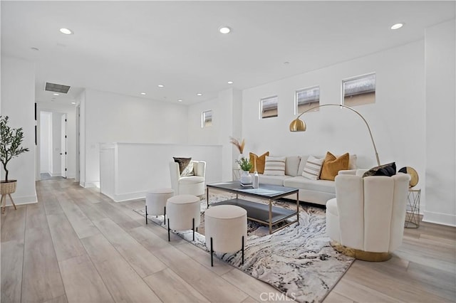 living room featuring recessed lighting, light wood finished floors, and visible vents