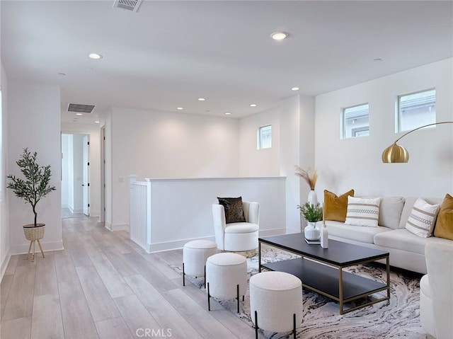 living area featuring light wood-type flooring, recessed lighting, and visible vents