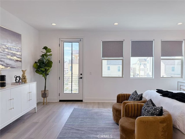 doorway with recessed lighting, light wood-style flooring, and a wealth of natural light