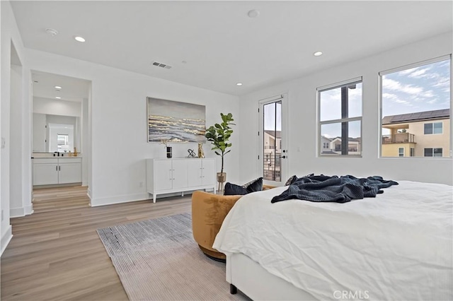 bedroom featuring light wood-style floors, multiple windows, recessed lighting, and visible vents