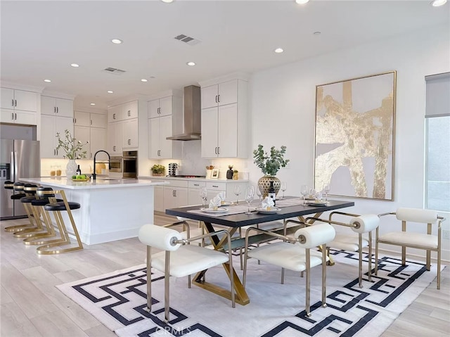 dining area featuring visible vents, recessed lighting, and light wood-style floors