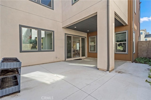 rear view of property featuring a patio area and stucco siding