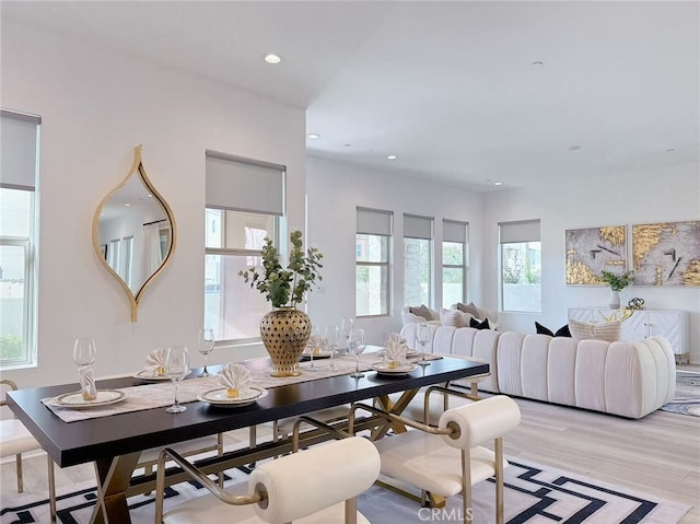dining room with recessed lighting and light wood-style flooring