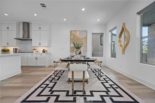 dining area with light wood-style floors, baseboards, recessed lighting, and visible vents