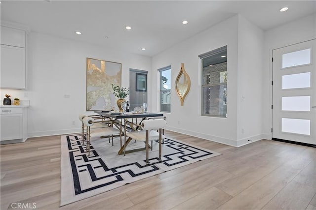 dining room featuring recessed lighting, baseboards, and light wood-style floors