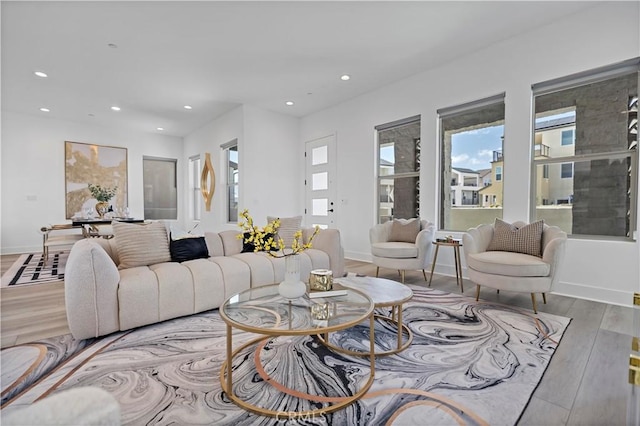 living area featuring recessed lighting, baseboards, and wood finished floors