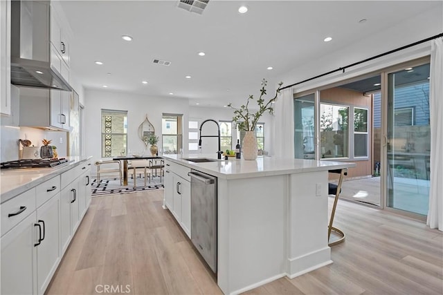 kitchen with visible vents, a sink, light wood-style floors, and stainless steel appliances