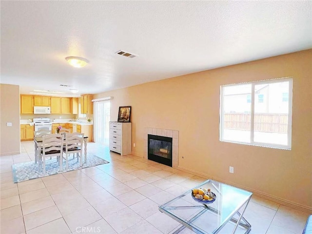14627 Palm St, Adelanto, CA 92301 - living area with light tile patterned flooring and a fireplace