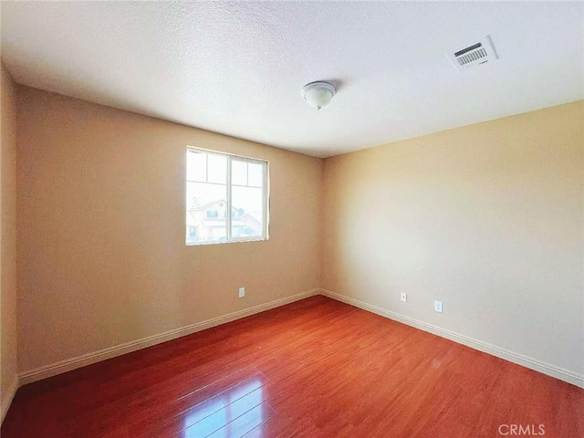 14627 Palm St, Adelanto, CA 92301 - unfurnished room with wood finished floors and baseboards