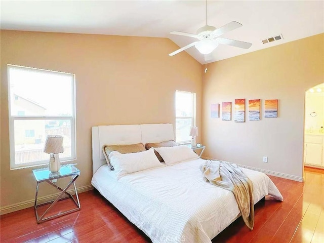 14627 Palm St, Adelanto, CA 92301 - bedroom featuring wood finished floors, vaulted ceiling, connected bathroom, and ceiling fan