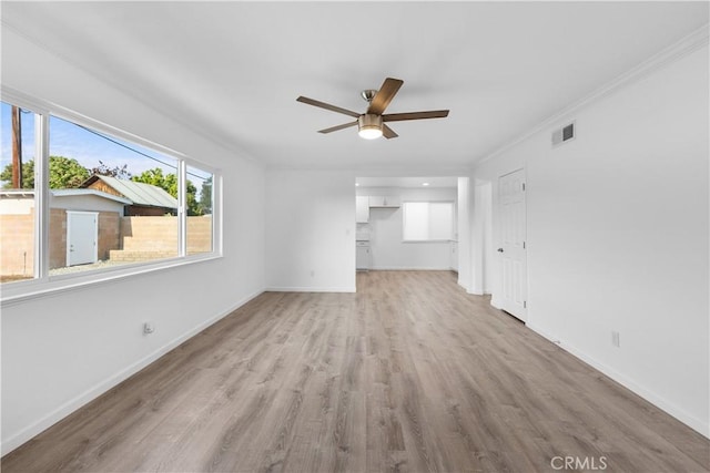 unfurnished living room with visible vents, baseboards, ceiling fan, and light wood-type flooring
