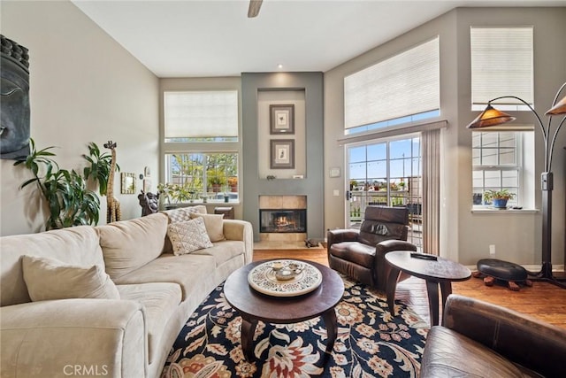 33046 Ocean Rdg, Dana Point, CA 92629 - living room featuring a tiled fireplace, a high ceiling, baseboards, and wood finished floors
