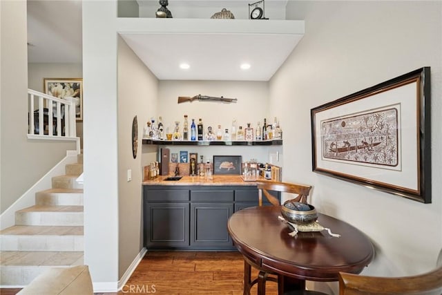 33046 Ocean Rdg, Dana Point, CA 92629 - bar with wet bar, wood finished floors, stairway, baseboards, and recessed lighting