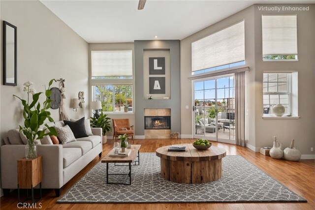 33046 Ocean Rdg, Dana Point, CA 92629 - living area featuring a towering ceiling, a tiled fireplace, and wood finished floors