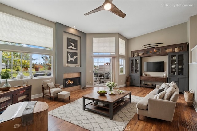 33046 Ocean Rdg, Dana Point, CA 92629 - living area featuring a ceiling fan, a high ceiling, wood finished floors, and a warm lit fireplace