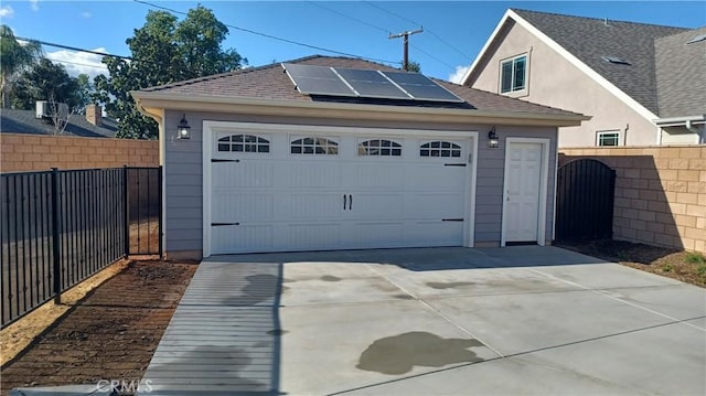 5183 Peony Ct, Riverside, CA 92506 - garage featuring driveway, solar panels, a gate, and fence