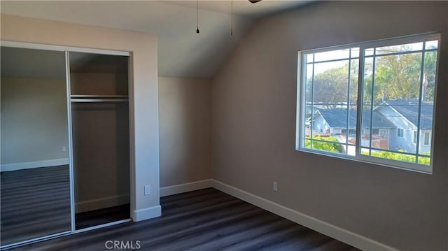5183 Peony Ct, Riverside, CA 92506 - unfurnished bedroom featuring vaulted ceiling, multiple windows, dark wood-style floors, and baseboards