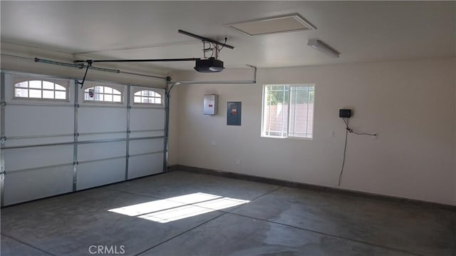 5183 Peony Ct, Riverside, CA 92506 - garage featuring baseboards, a garage door opener, and electric panel