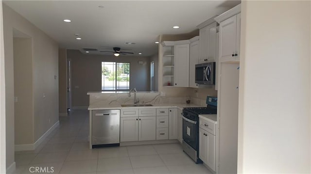 5183 Peony Ct, Riverside, CA 92506 - kitchen with open shelves, appliances with stainless steel finishes, a sink, white cabinetry, and a peninsula