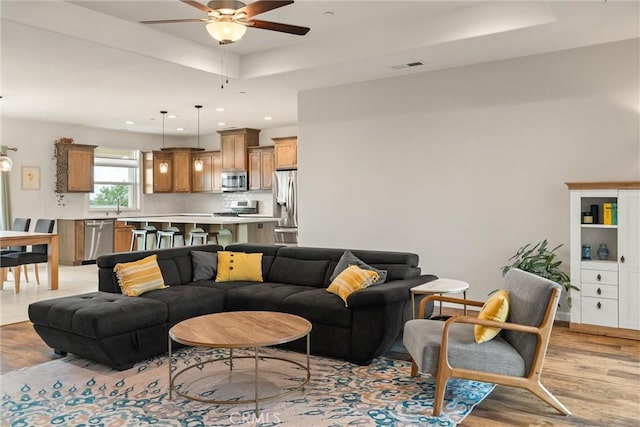1982 Dawncrest Dr, Chico, CA 95928 - living area with a raised ceiling, light wood-style floors, visible vents, recessed lighting, and a ceiling fan