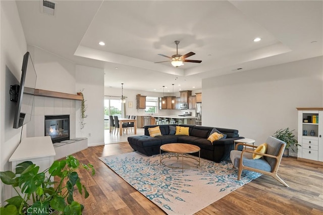 1982 Dawncrest Dr, Chico, CA 95928 - living area with a ceiling fan, visible vents, wood finished floors, and a tray ceiling