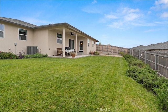 1982 Dawncrest Dr, Chico, CA 95928 - back of house with ceiling fan, a fenced backyard, stucco siding, and a yard