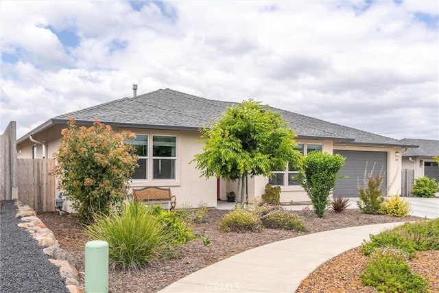 1982 Dawncrest Dr, Chico, CA 95928 - view of front of house with stucco siding, fence, a shingled roof, concrete driveway, and an attached garage