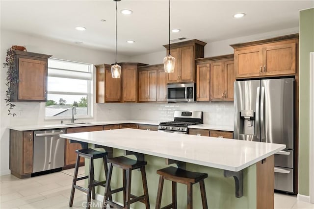 1982 Dawncrest Dr, Chico, CA 95928 - kitchen featuring a sink, tasteful backsplash, a kitchen island, hanging light fixtures, and appliances with stainless steel finishes