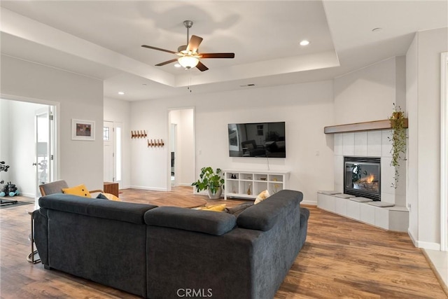 1982 Dawncrest Dr, Chico, CA 95928 - living room with recessed lighting, a tiled fireplace, ceiling fan, a tray ceiling, and wood finished floors