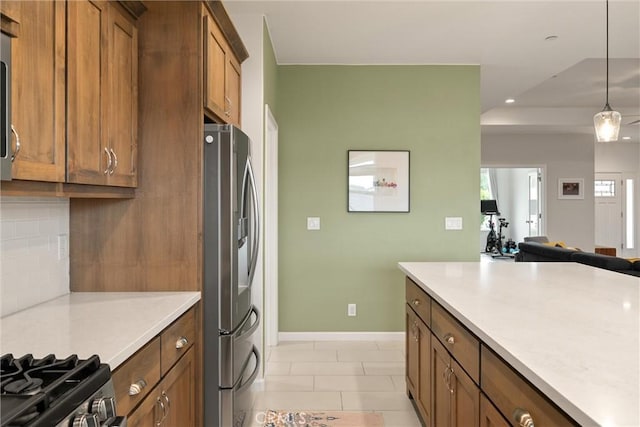1982 Dawncrest Dr, Chico, CA 95928 - kitchen featuring decorative backsplash, brown cabinetry, stainless steel appliances, light countertops, and open floor plan