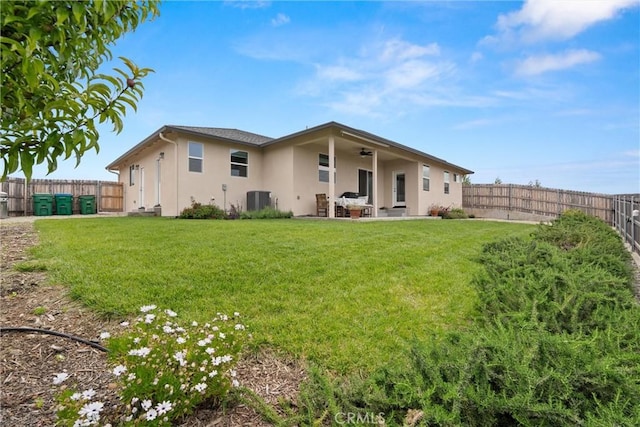 1982 Dawncrest Dr, Chico, CA 95928 - back of house with a lawn, ceiling fan, central air condition unit, stucco siding, and a fenced backyard