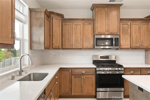 1982 Dawncrest Dr, Chico, CA 95928 - kitchen featuring tasteful backsplash, a sink, appliances with stainless steel finishes, and light countertops