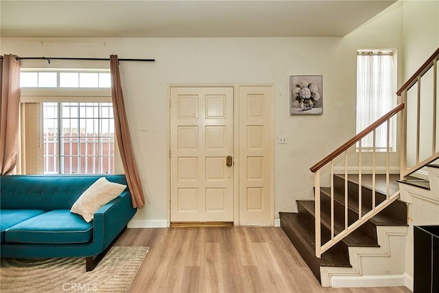 foyer with stairs and wood finished floors