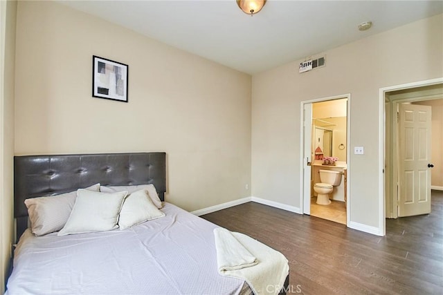 bedroom featuring baseboards, visible vents, connected bathroom, and dark wood-type flooring
