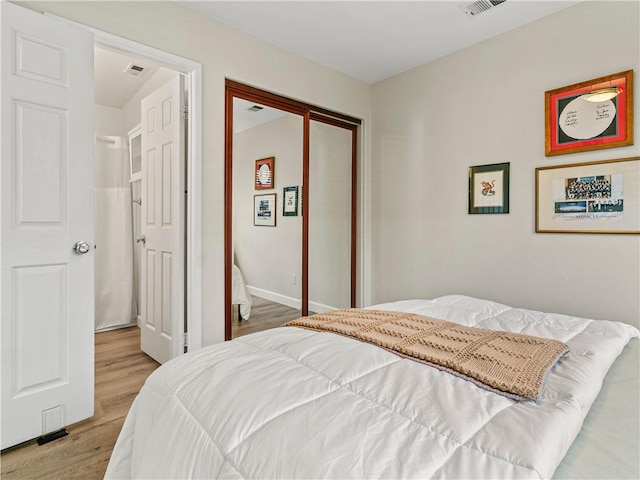 bedroom featuring visible vents and light wood-type flooring