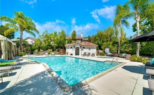 pool featuring a patio and a community hot tub