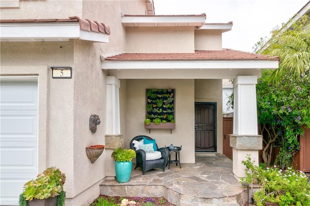view of exterior entry featuring stucco siding