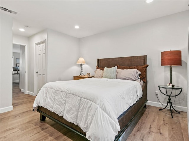 bedroom featuring visible vents, baseboards, and light wood-type flooring