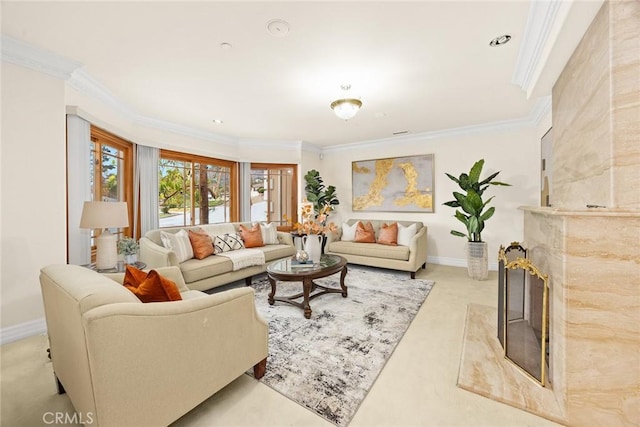 living area with carpet, a premium fireplace, crown molding, and baseboards