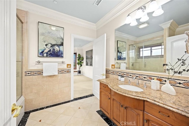 full bathroom with tiled shower, vanity, crown molding, visible vents, and tile patterned flooring