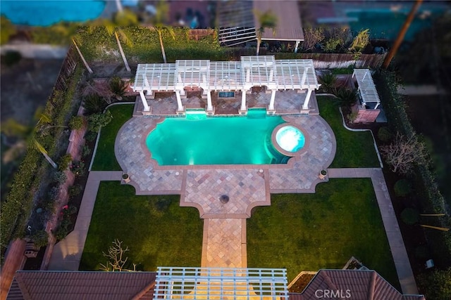 pool with a lawn and a patio area