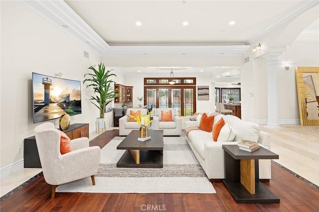 living room with recessed lighting, arched walkways, wood-type flooring, ornate columns, and crown molding