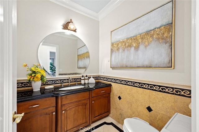 bathroom with crown molding, toilet, tile walls, tile patterned floors, and vanity