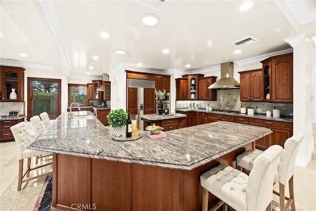 1774 Orangewood Ln, Arcadia, CA 91006 - kitchen featuring wall chimney range hood, stainless steel appliances, a large island with sink, a kitchen breakfast bar, and recessed lighting