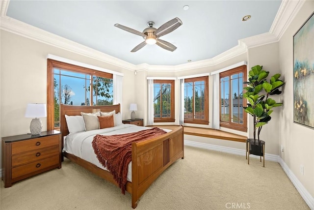 bedroom with crown molding, ceiling fan, light carpet, and baseboards