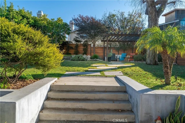view of yard with fence and a pergola