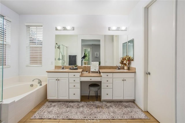 bathroom with a garden tub, vanity, tile patterned flooring, and a stall shower
