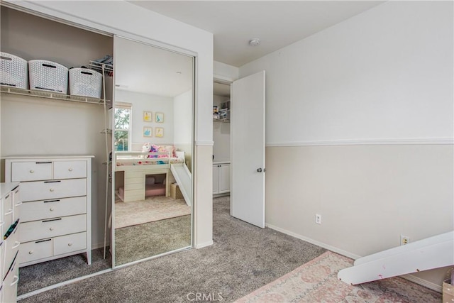 carpeted bedroom featuring baseboards