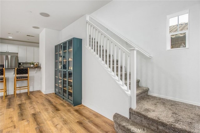staircase with wood finished floors